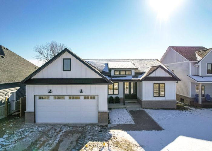 White siding and stone ranch house.