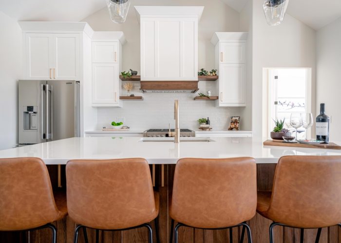 A vaulted ceiling, custom kitchen with quartz countertops.