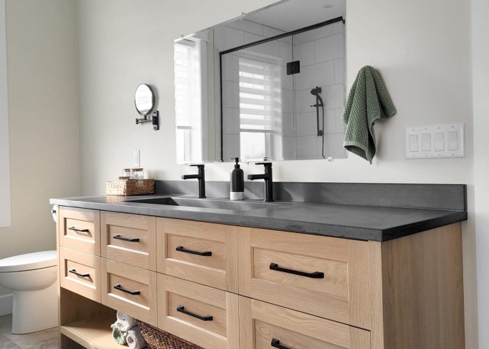 A bathroom vanity, made of solid white oak wood with a custom concrete countertop.